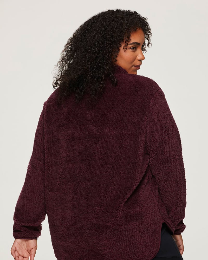 Back of a model wearing a size 1X Dylan 1/4-Zip Sherpa Pullover in Dark Red by RBX Active. | dia_product_style_image_id:281973